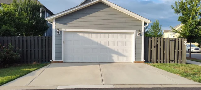Concrete driveway before pressure washing showing accumulated surface discoloration.